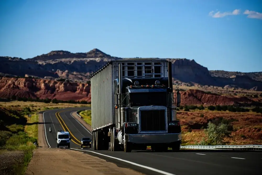 Car carrier truck in Phoenix, Arizona, with desert mountains in the background