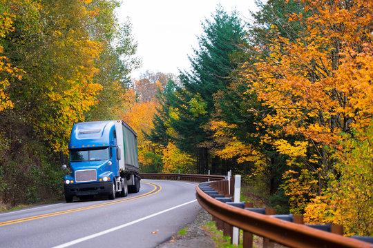 Car hauler truck driving through Blue Ridge Mountains in Virginia, autumn scenery
