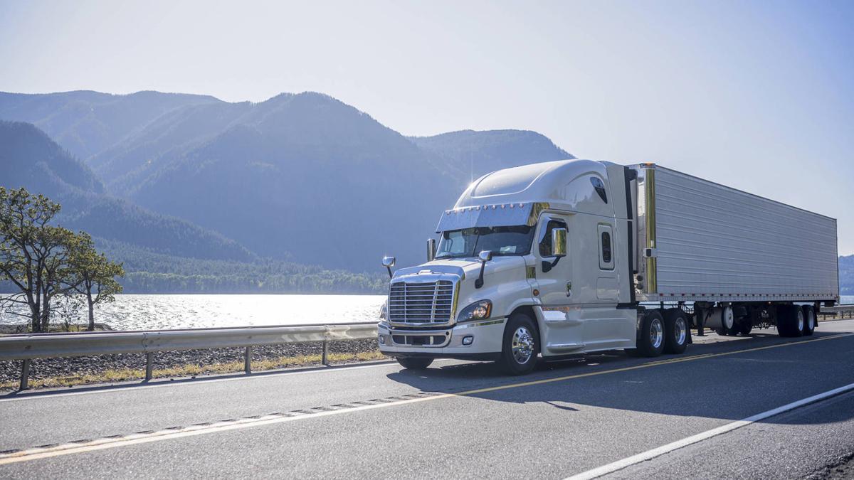 Professional car shipping truck transporting vehicles on highway