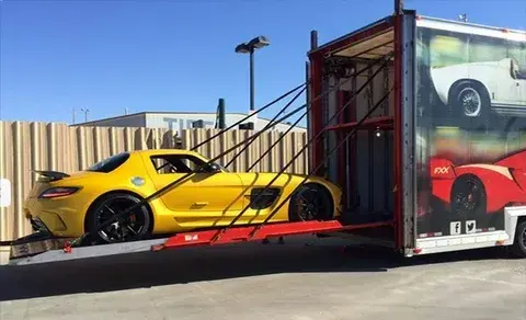 Enclosed trailer delivering luxury vehicle to Florida